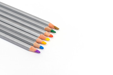 gray wooden pencils with colored rods on a white background
