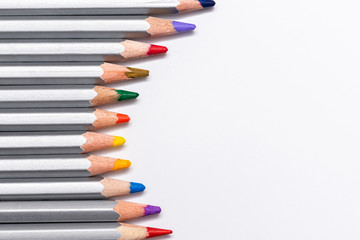 Naklejka premium gray wooden pencils with colored rods on a white background