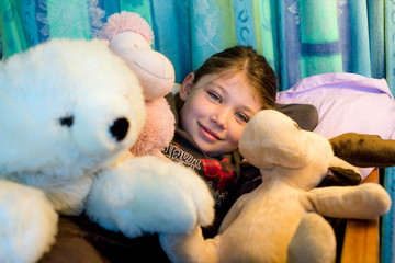 cute little girl reassuring herself with her stuffed animals