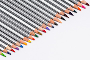 gray wooden pencils with colored rods on a white background