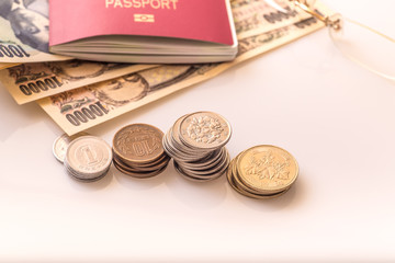 Japanese coins and banknotes and passport on white table