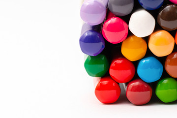 colored back of wooden gray pencils with colored rods on a white background