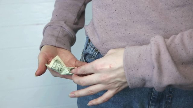 One dollar and petty cash only, empty pocket. No money. Economy crisis, poverty, unemployment concept. Consequences of coronavirus people isolation during quarantine. Inflation rates. Price growth.