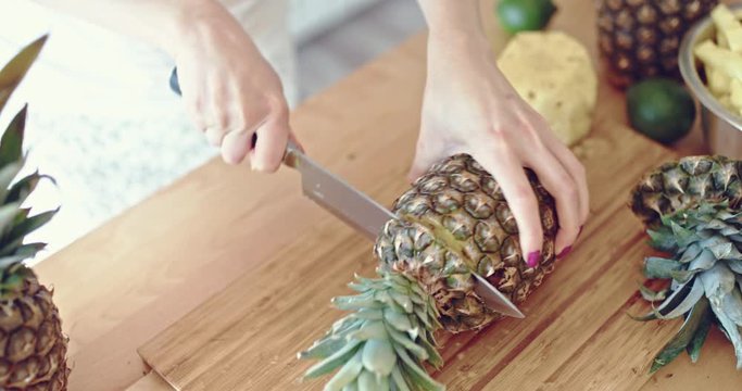 Knife cut fresh pineapple sliced in the kitchen. Natural juicy raw pineapple slice. Close up pineapple
