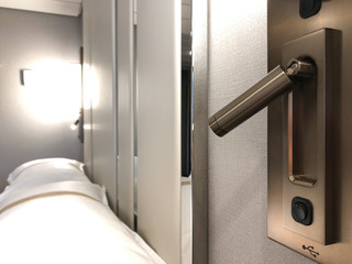 LED reading light and USB port with bed inside stateroom or cabin or suite on luxury cruiseship or...