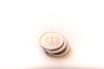 Japanese coins and banknotes and passport on white table