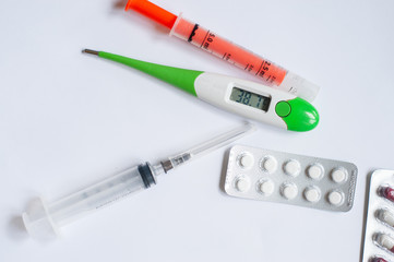 Medical concept. Drugs, thermometer and syringe. Copy space. Top view