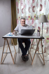 Mature man with a beard working at home