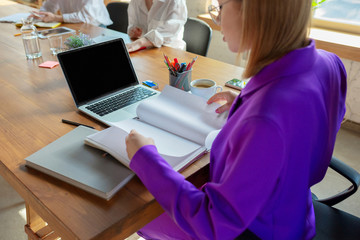 Detailes. Young caucasian business woman in modern office with team. Meeting, tasks giving. Women in front-office working. Concept of finance, business, girl power, inclusion, diversity, feminism.