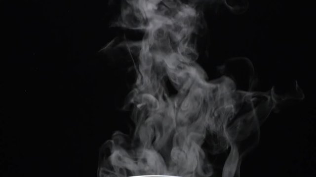 Closeup of white smoke in slow motion on black background