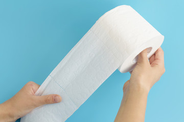 text fake news on white toilet paper on blue background, concept of lie in social media during coronavirus pandemic in the world