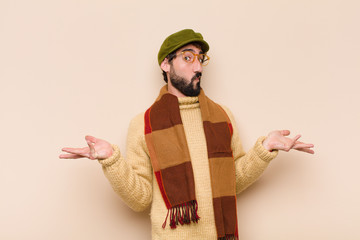 young cool bearded man feeling puzzled and confused, unsure about the correct answer or decision,...