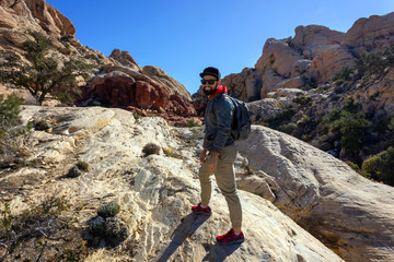 smiling man tourist backpacker in red rock mountains landscape Red Rock Canyon National Conservation Area Nevada’s Mojave Desert