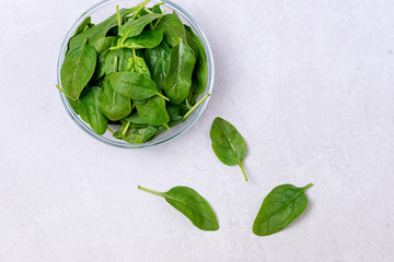 Ripe Spinach in the Bowl on the Light Gray background Spinach Leaves Top View Horizontal Copy Space