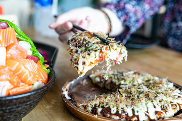 Japanese okonomiyaki or Pizza japan on a table. horizontal top view
