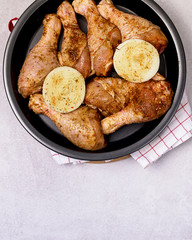 Spicy Glazed Chicken Legs on Black Plate Ready to Cook Homemade Food Concept for a Tasty and Healthy Dish. Gray Background Top View