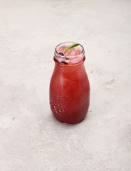 lemonade, lemonade with ice in a glass bottle on a white background