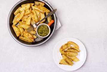 Roasted or Baked Potatoes With Spice in Black Bowl on Light Gray Background Tasty Homemade Dish Dinner Grilled Potatoes Top View Horizontal