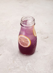 lemonade, lemonade with ice in a glass bottle on a white background