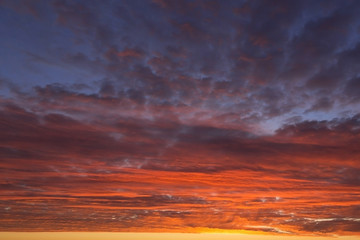Fototapeta na wymiar Epic Dramatic bright sunrise, sunset orange yellow pink blue sky with clouds background texture, heaven