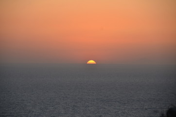 Fototapeta premium Sunset over the sea in Santorini. - Greece
