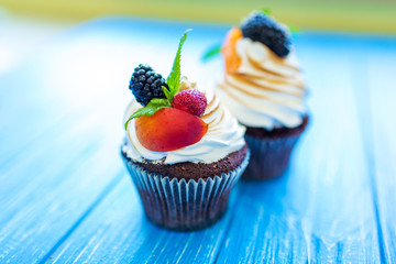 Freshly baked sweet muffins on a blue background. Sweet pastries, recipes, cooking