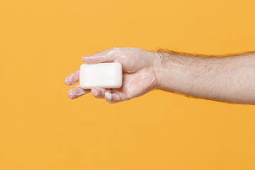 Close up cropped of male hold wash hand antibacterial antiseptic sanitizer soap foam isolated on yellow background. Epidemic pandemic hygiene coronavirus 2019-ncov covid-19 flu virus Mockup copy space