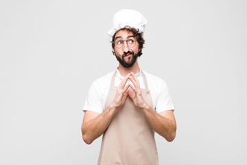 young crazy chef scheming and conspiring, thinking devious tricks and cheats, cunning and betraying...