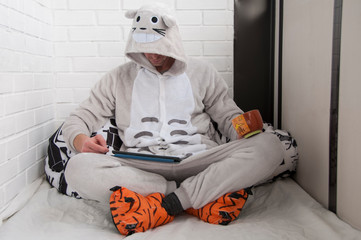 Man in a funny pajamas with a digital tablet. Working from home. 