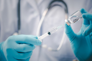 Concept fight against virus covid-19 corona virus, doctor or scientist in laboratory holding a syringe with liquid vaccines for children or older adults,Concept:diseases,medical care,science.