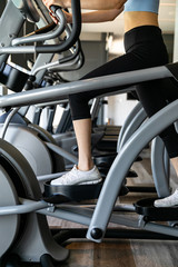 young women working out on stepper at gym