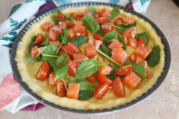 Quiche Lorraine with fish and spinach, stages of cooking