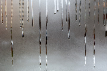 abstract background of wet window glass with water drop smudges - close-up with selective focus and...