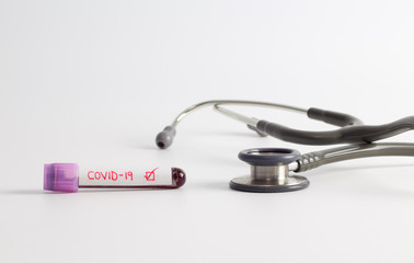 Positive result Coronavirus(Covid-19) blood sample vacuum tube with stethoscope on white background