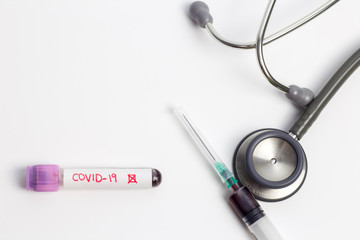 Negative result Coronavirus(Covid-19) blood sample vacuum tube and injection syringe with stethoscope on white background