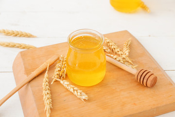 Jar of sweet honey on table