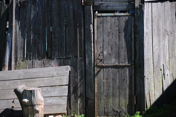 Old plank wooden wall with a door