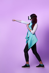 Woman is using virtual reality headset, playing game and fighting.