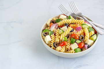 Mediterranean Fusilli Pasta Salad with Tomatoes, Black Olives, Cucumber, Mozzarella lose Up Horizontal Photo