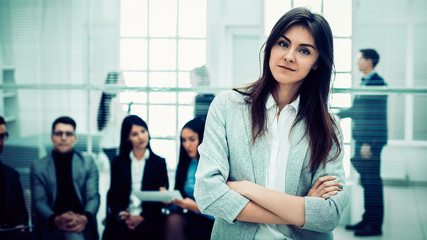 successful young business woman standing in office.