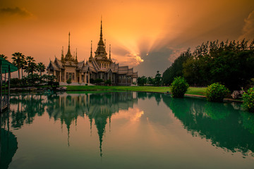 Obraz premium Wallpaper Wat Lan Boon Mahawihan Somdet Phra Buddhacharn(Wat Non Kum)is the beauty of the church that reflects the surface of the water, popular tourists come to make merit and take a public photo
