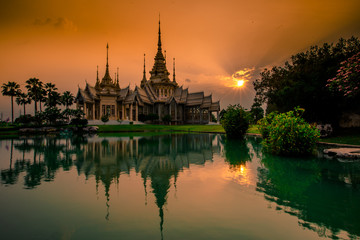 Obraz premium Wallpaper Wat Lan Boon Mahawihan Somdet Phra Buddhacharn(Wat Non Kum)is the beauty of the church that reflects the surface of the water, popular tourists come to make merit and take a public photo