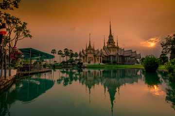 Fototapeta na wymiar Wallpaper Wat Lan Boon Mahawihan Somdet Phra Buddhacharn(Wat Non Kum)is the beauty of the church that reflects the surface of the water, popular tourists come to make merit and take a public photo