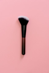 makeup brush on pink background