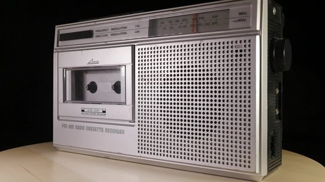 Cassette Radio Recorder rotating before black background