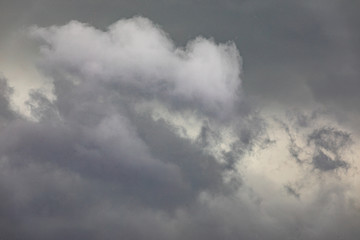 Black clouds fill the sky in a heavy rainy city.