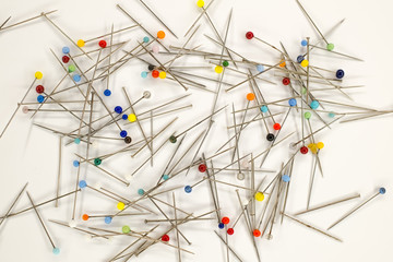 Colorful pins on white background