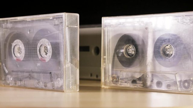Cassette Tapes rotating before black background