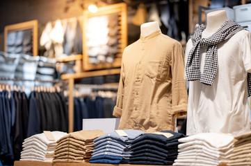 Trendy cotton Men shirt display on mannequin in clothes shop. Summer collection fashion product samples in clothing store for selling. Textile industry and business concept - 334796865