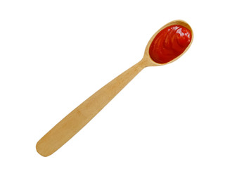 wooden spoon with ketchup isolated on a white background